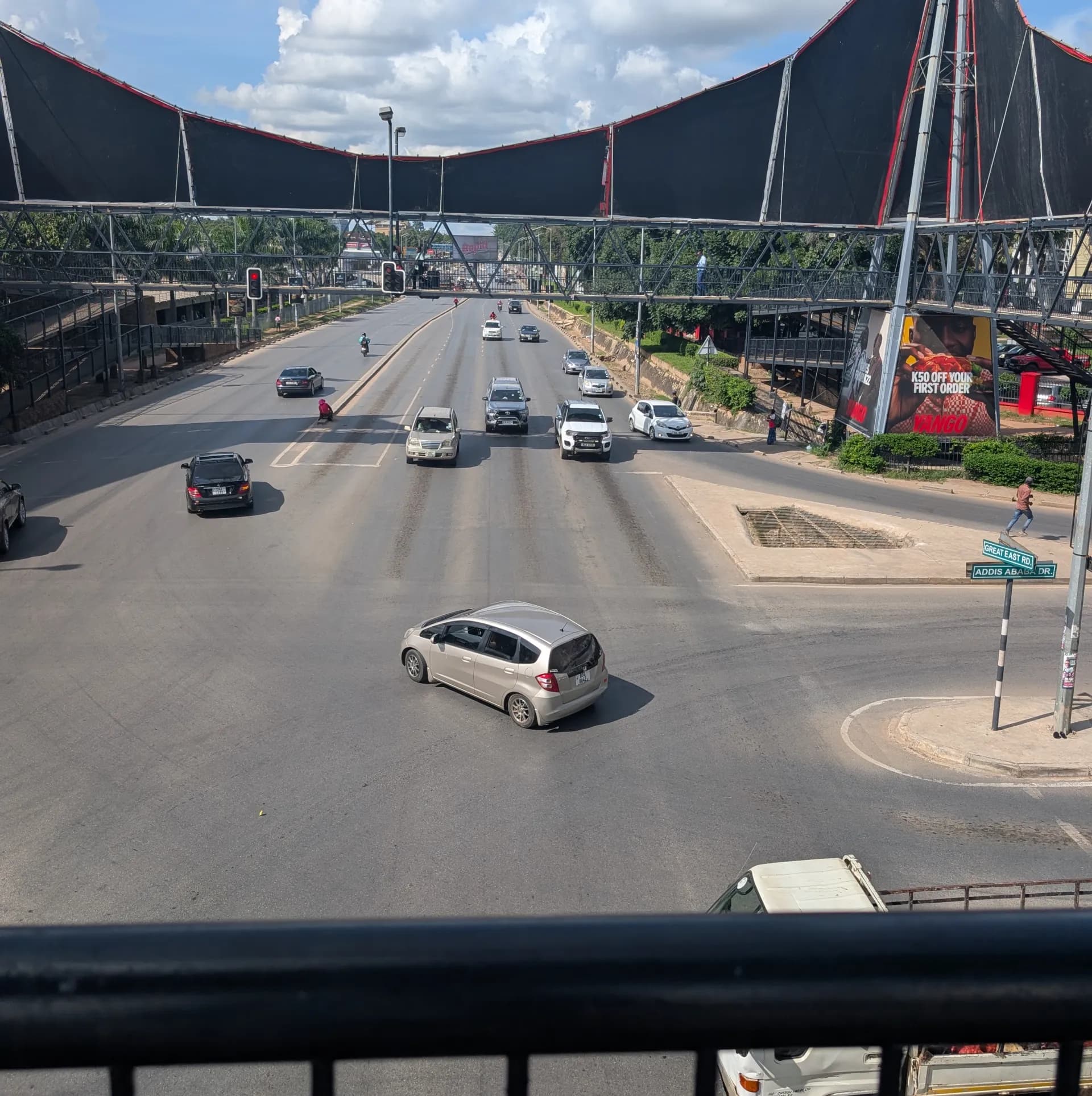 On a footbridge overlooking traffic in Lusaka