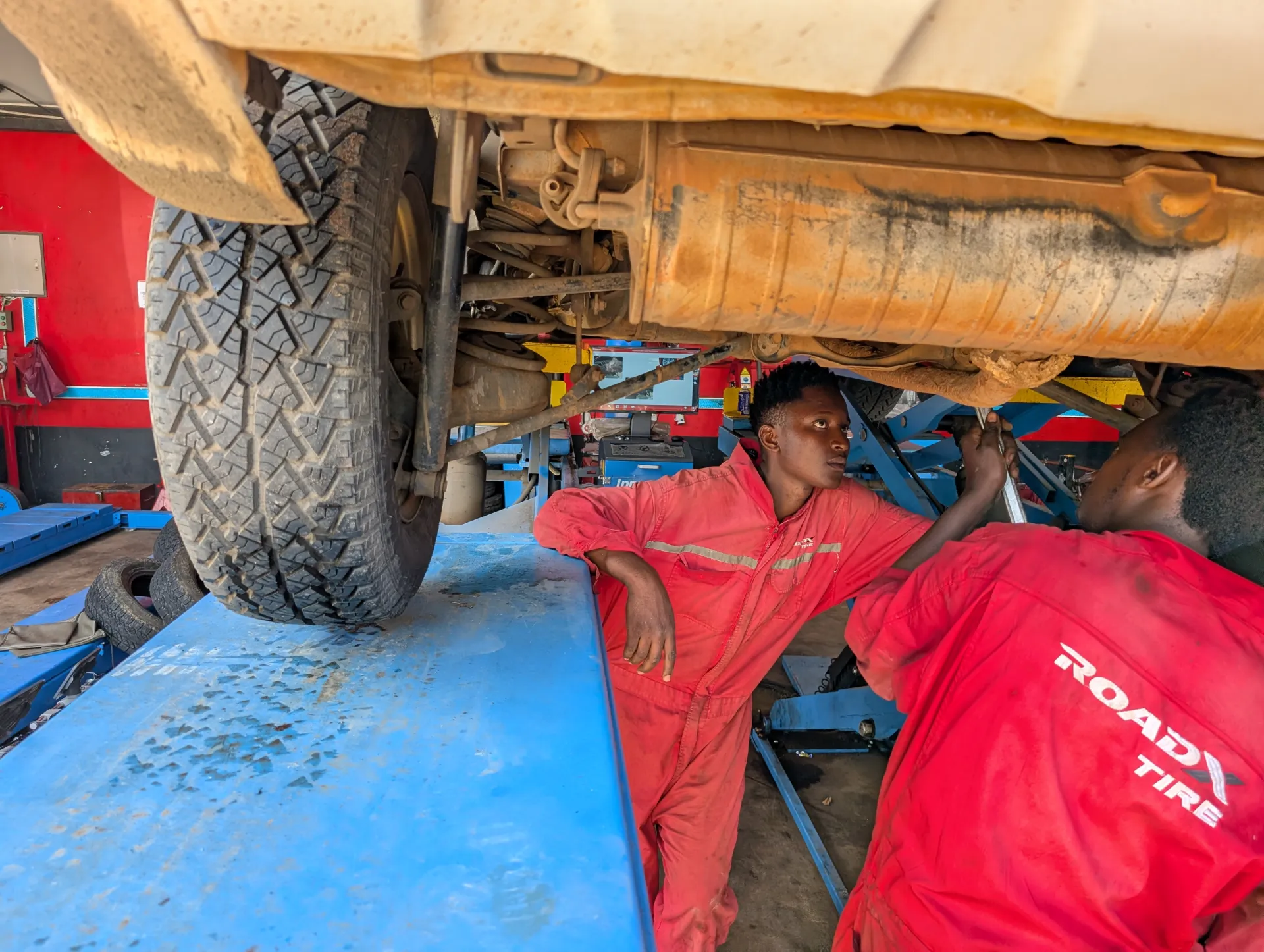 Mechanics checking the suspension of the car